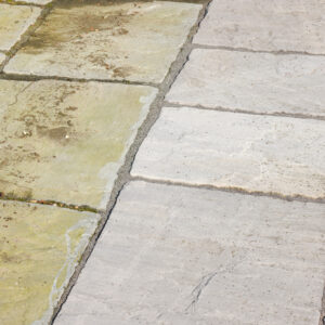 Cleaning sandstone paving. Garden patio before and after jet washing or pressure washing, UK.